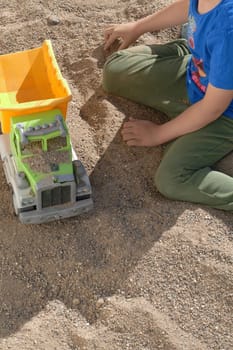 children playing in the sand, happy children playing in the sand in the garden,