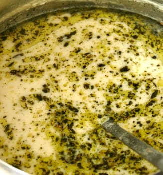 Delicious Turkish Yogurt Soup with mint, cooked in a large pot