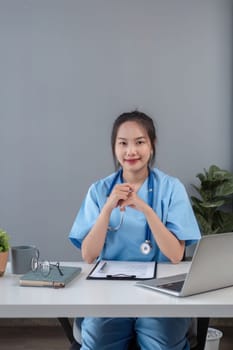 Young asian woman wearing doctor uniform smiling confident looking at the camera.