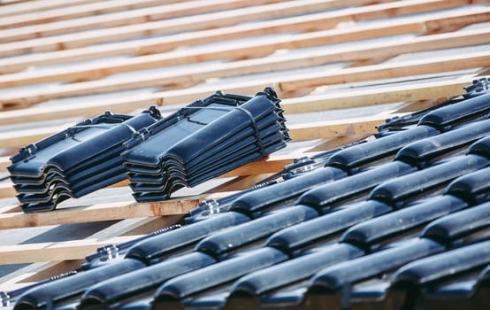 Black roof of burnt tiles reconstruction for the old house, building concept, an expensive building material