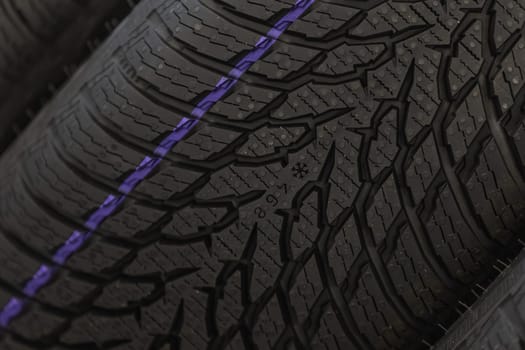 Close up of new winter tires for a cold season, vehicle service concept