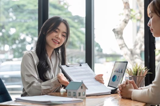 Real estate agent discuss about the terms of the home purchase agreement and asked the customer to sign the documents to make the contract legally, Home sales, lease, mortgage and home insurance..
