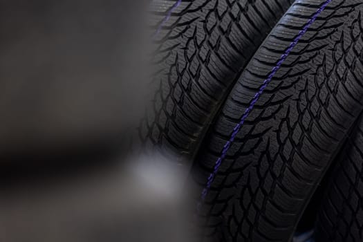 Close up of new winter tires for a cold season, vehicle service concept