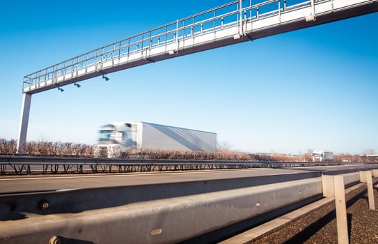 Trucks passing through the toll gate on the highway, highway fee, industrial and transport concept