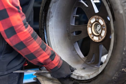 Process of wheel balancing at a car service, transport concept