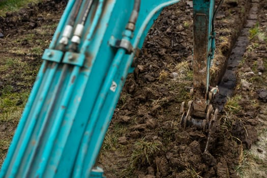 Close up of excavator or digger digging some soil or clay, industrial concept