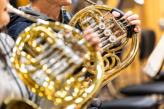 French horn instrument, hands playing horn player in the philharmonic orchestra