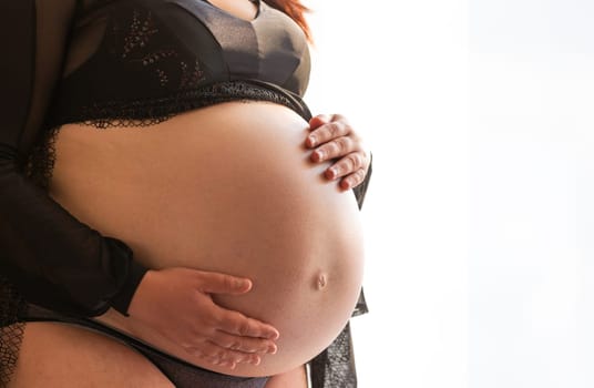 Young pregnant woman with belly, a pregnancy concept