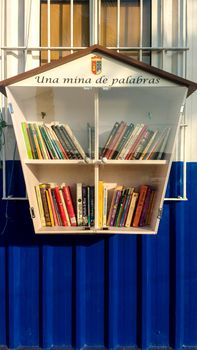 Portman, Cartagena, Spain- July 19, 2021: Street library available to the public on the beach of Portman village in summer