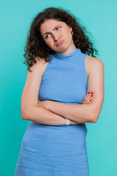 Sad woman feeling hopelessness loneliness, nervous breakdown, loses becoming surprised by lottery results, bad fortune, loss unlucky news. Young adult girl isolated on studio blue background. Vertical