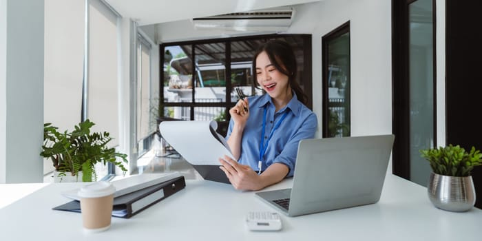 female accountant working on a tablet computer in a modern office. Make an account analysis report. real estate investment information financial and tax system concepts.