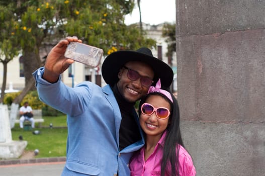 black man with his daughter taking a selfie on a summer trip. High quality photo