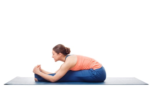 Sporty fit woman doing Ashtanga Vinyasa yoga back bending asana Paschimottanasana - seated forward bend isolated on white