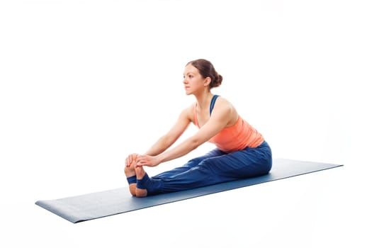 Woman doing Ashtanga Vinyasa Yoga asana Paschimottanasana - seated forward bend pose beginner variation isolated on white background