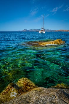 Yacht boat in Aegean sea at white rocks of Sarakiniko Beach, Milos island , Greece