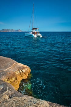 Yacht boat in Aegean sea at white rocks of Sarakiniko Beach, Milos island , Greece