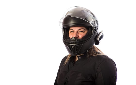 Forty year old woman, wearing motocycle clothing, with helmet and visor up, isolated on a white background