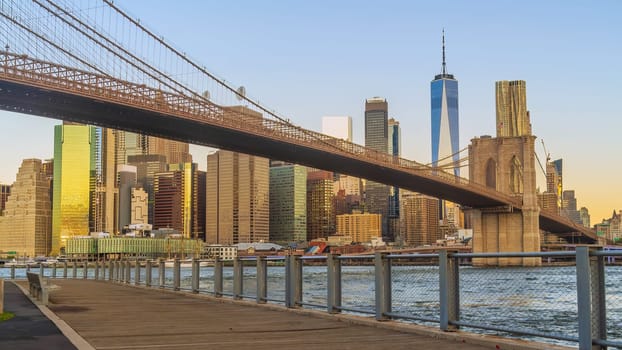 Manhattan's skyline with Brooklyn bridge, cityscape of New York City in the United States of America at sunrise