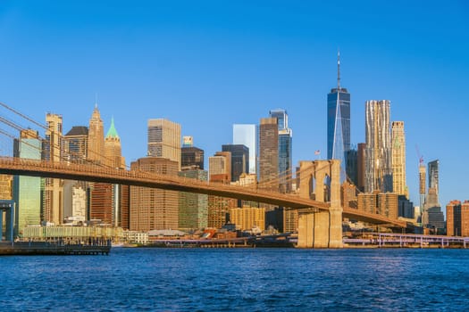 Manhattan's skyline with Brooklyn bridge, cityscape of New York City in the United States of America at sunrise