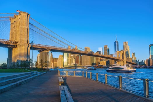 Manhattan's skyline with Brooklyn bridge, cityscape of New York City in the United States of America at sunrise