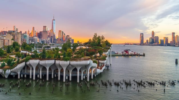 Cityscape of downtown Manhattan skyline with the Little Island Public Park in New York City at sunrise