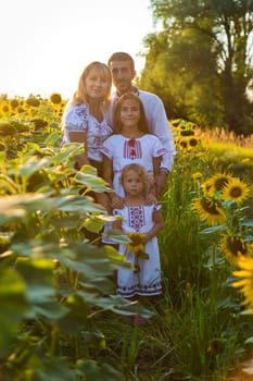 Family Ukraine in the field of sunflowers. Selective focus. Nature.