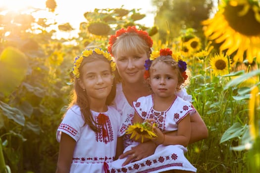 Family Ukraine in the field of sunflowers. Selective focus. Nature.