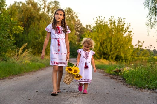 A child in a field of sunflowers Ukraine. Selective focus. Nature.