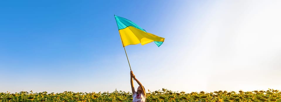 Child with the flag of Ukraine. Selective focus. Nature.