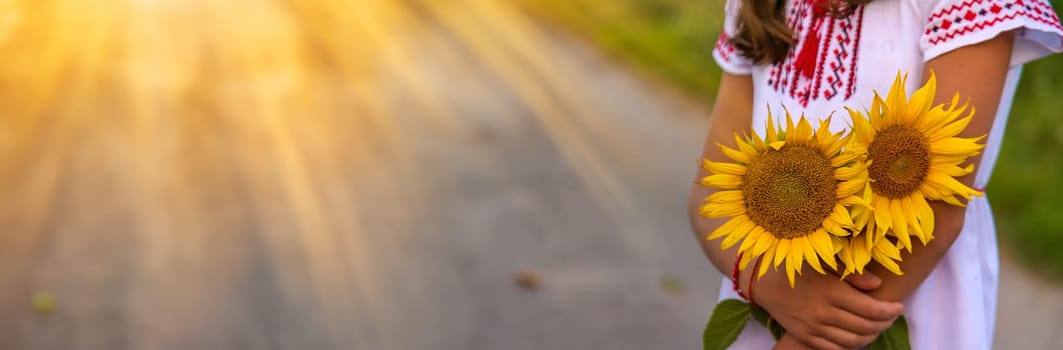 A child in a field of sunflowers Ukraine. Selective focus. Nature.