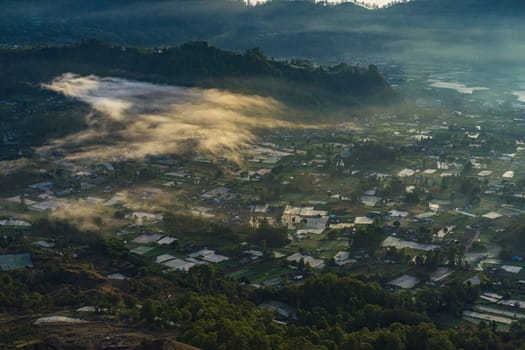 Beautiful landscape view of rural location near the mountain Batur. Morning village at the foot of the mountain