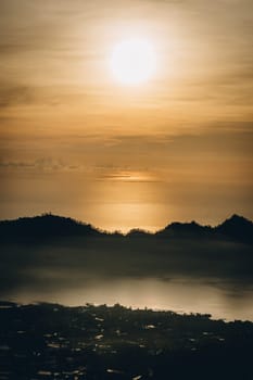 Early morning sunrise clouds at mountain Batur. Dawn mist covering volcano Batur