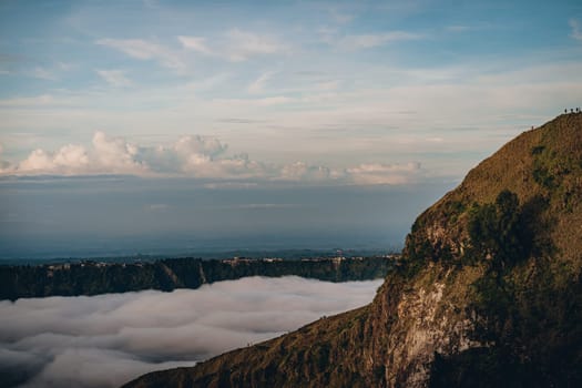 Landscape view of morning clouds and mist at mountain Batur. Sunrise trekking mount volcano Batur