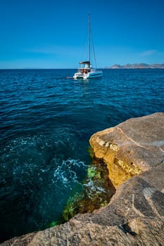 Yacht boat in Aegean sea at white rocks of Sarakiniko Beach, Milos island , Greece