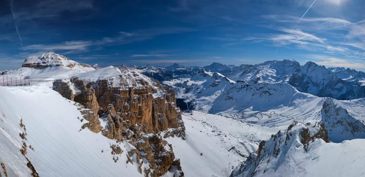 Panorama of a ski resort piste and Dolomites mountains in Italy from Passo Pordoi pass. Arabba, Italy