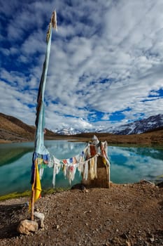 Small gompa with buddhist prayer flags at sacred Dhankar Lake. Spiti Valley, Himachal Pradesh, India