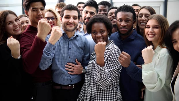 Confident diverse college students show fist up. success concept