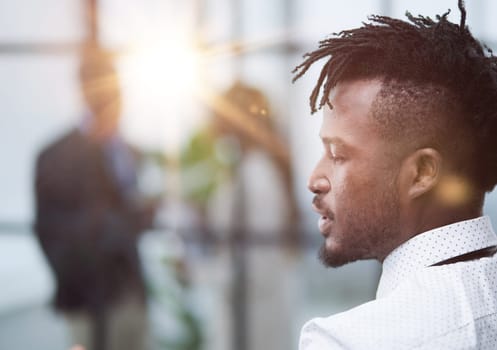 Portrait of a middle-aged african man standing with his back