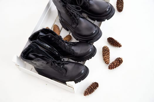 Female winter, autumn or spring black leather shoes in studio. Fashionable modern photography for store, catalog, magazine or online