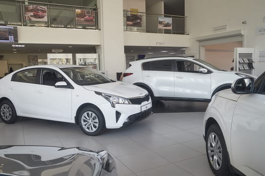 Kirov, Russia - April 12, 2022: Cars in showroom of dealership Kia in Kazan in Russia. Partial focus