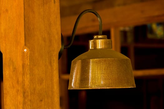 Old brass lamp with wooden pole