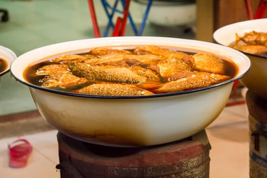 Carp boiled in sweet sauce and brown salt in the pan. Is a local food of Thailand