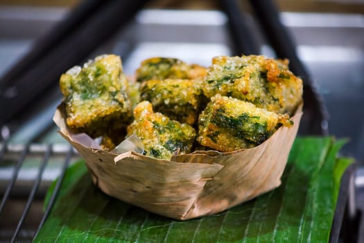 steamed chives dumplings in a container from dried banana leaves