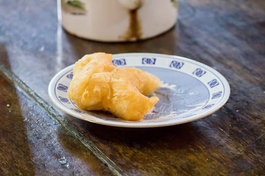 chinese bread stick in a plate on the table