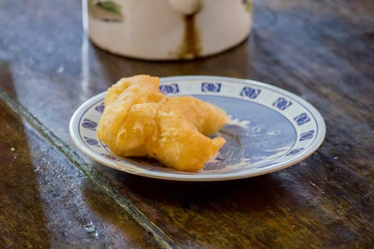 chinese bread stick in a plate on the table