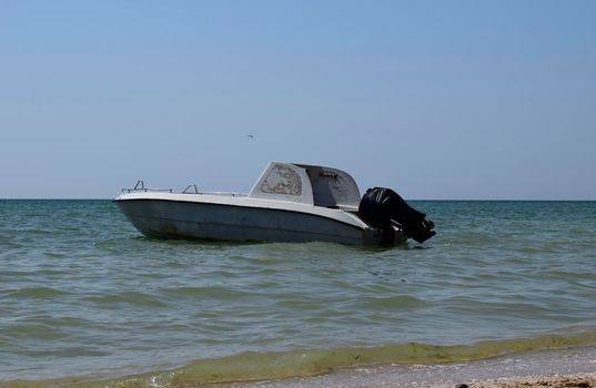 Motor boat on the background of the sea near the coast.