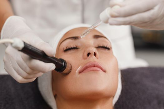 Shot of a beautiful young woman on a facial mesotherapy non needle treatment at the beauty salon.