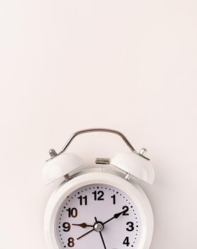 Time management, punctuality, business metaphors. White vintage alarm clock with nine ten , flat lay top view, copy space