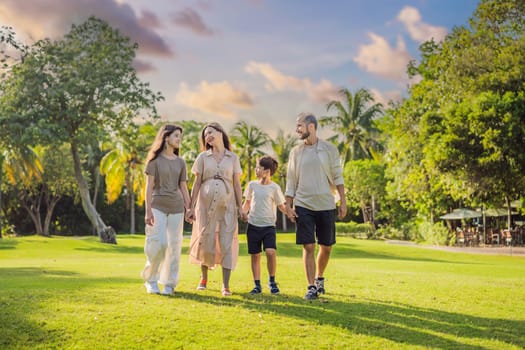 A loving family enjoying a leisurely walk in the park - a radiant pregnant woman after 40, embraced by her husband, and accompanied by their adult teenage children, savoring precious moments together amidst nature's beauty. Pregnancy after 40 concept.