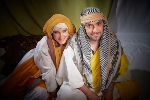 A couple in love or a married couple in stylized Eastern clothing from Israel, Palestine, Iran, Pakistan together. Tender photo session in the style of the Middle East and the Bible